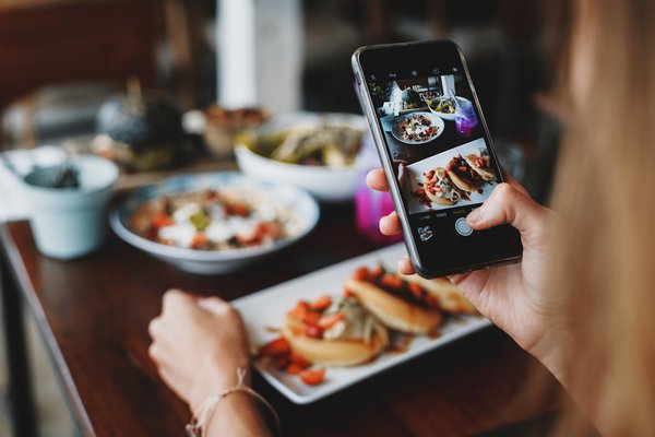 How can you leverage social media to promote a new restaurant opening?